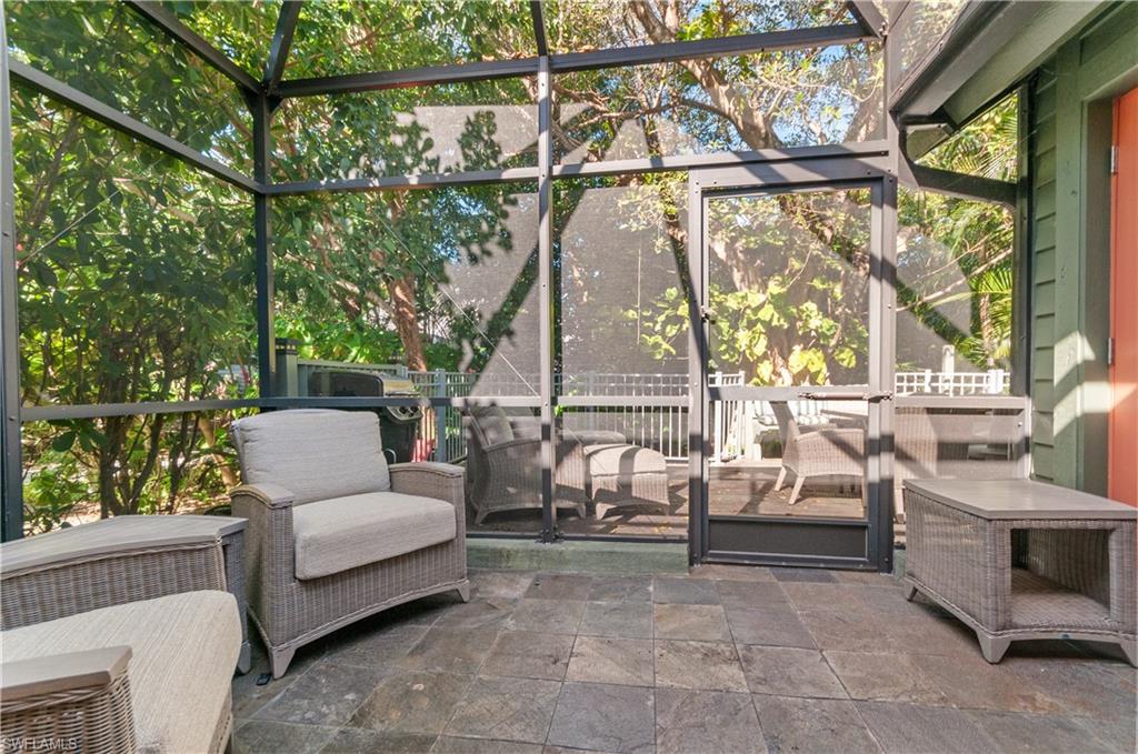 1313 Solana Road, Unit A3 Naples, FL 34103 - Photo 24 of 29 Screened in porch featuring an outdoor hangout area