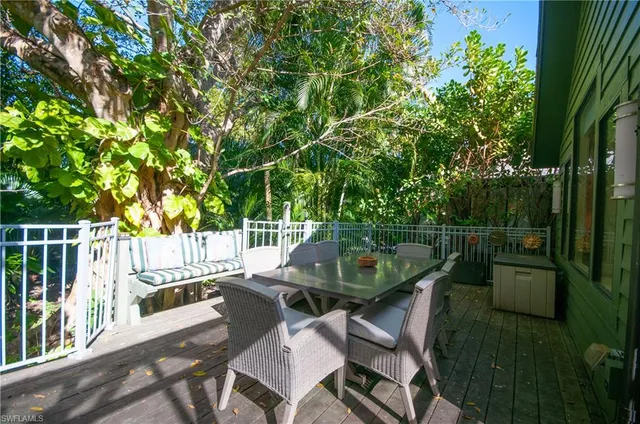 a view of a chairs and table in patio with wooden fence