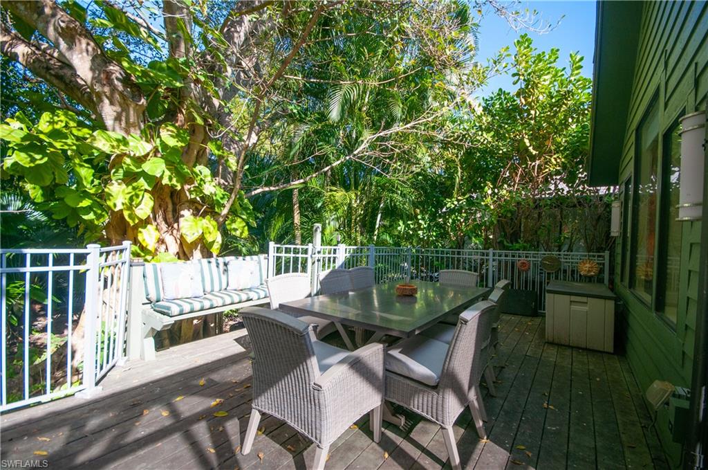 1313 Solana Road, Unit A3 Naples, FL 34103 - Photo 25 of 29 Wooden deck with outdoor dining area