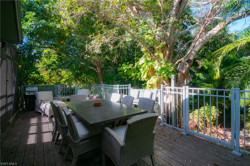 1313 Solana Road, Unit A3 Naples, FL 34103 - Photo 26 of 29 Wooden terrace with outdoor dining area