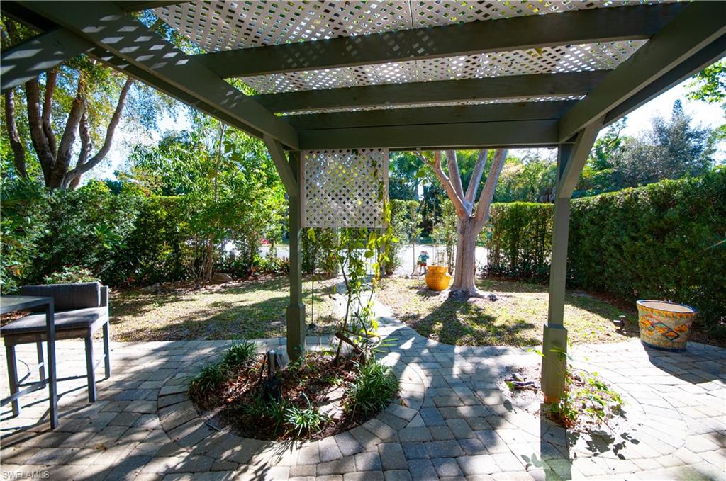 1313 Solana Road, Unit A3 Naples, FL 34103 - Photo 3 of 29 COURTYARD PERGOLA GARDEN PAVERS TO FRONT