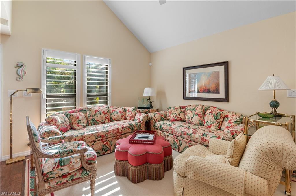 1313 Solana Road, Unit A3 Naples, FL 34103 - Photo 9 of 29 Living room with high vaulted ceiling and baseboards