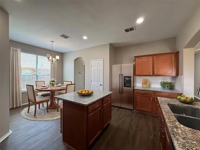 a kitchen with sink cabinets and wooden floor