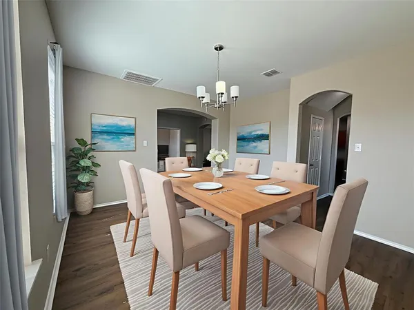 a view of a dining room with furniture and wooden floor