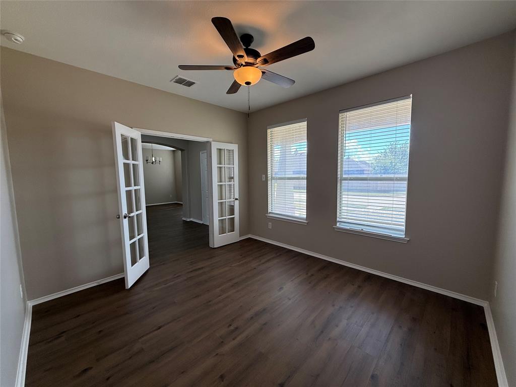 109 Rockbrook Drive Wylie, TX 75098 - Photo 17 of 34 a view of an empty room with wooden floor and a window