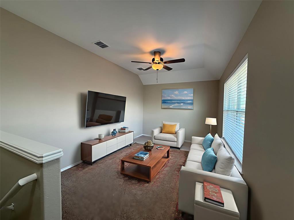 109 Rockbrook Drive Wylie, TX 75098 - Photo 18 of 34 a living room with furniture and a flat screen tv