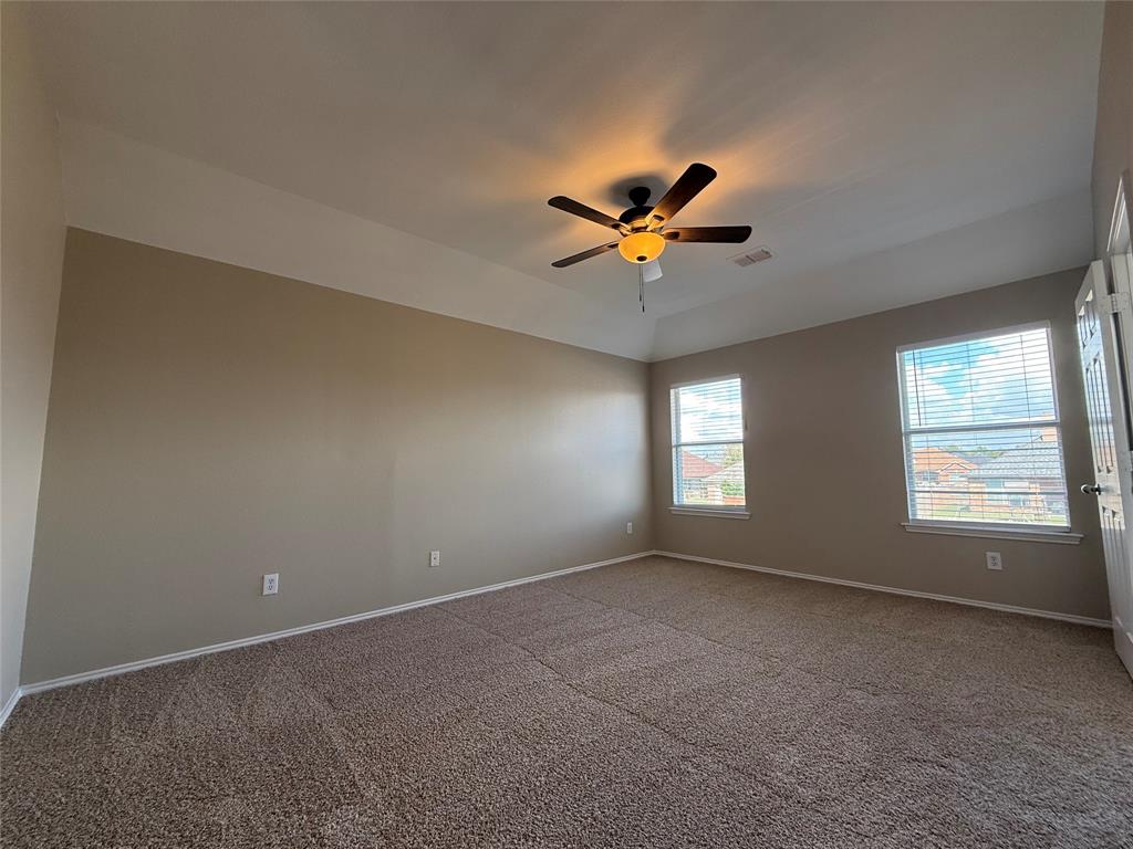 109 Rockbrook Drive Wylie, TX 75098 - Photo 21 of 34 an empty room with a window and a fan