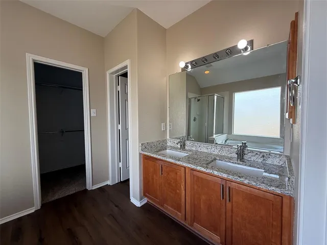 a bathroom with a granite countertop sink and mirror