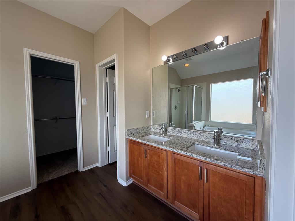 109 Rockbrook Drive Wylie, TX 75098 - Photo 22 of 34 a bathroom with a granite countertop sink and mirror