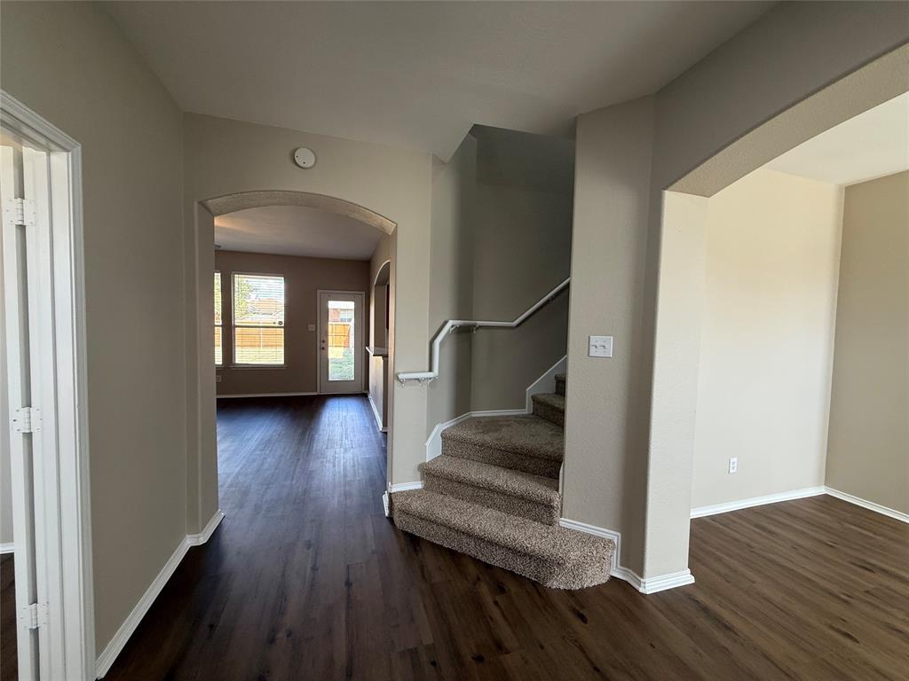109 Rockbrook Drive Wylie, TX 75098 - Photo 3 of 34 a view of a livingroom with wooden floor and stairs