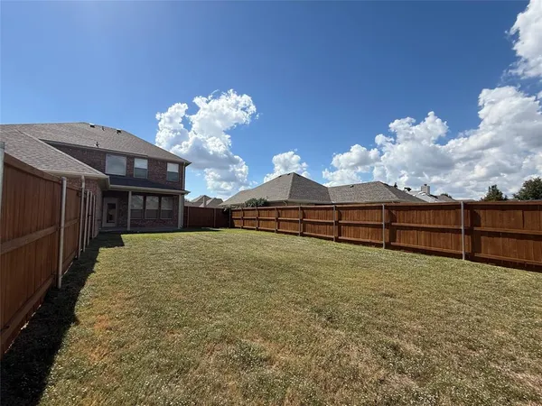 a view of a backyard of the house