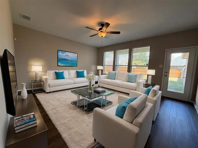 a living room with furniture and a flat screen tv