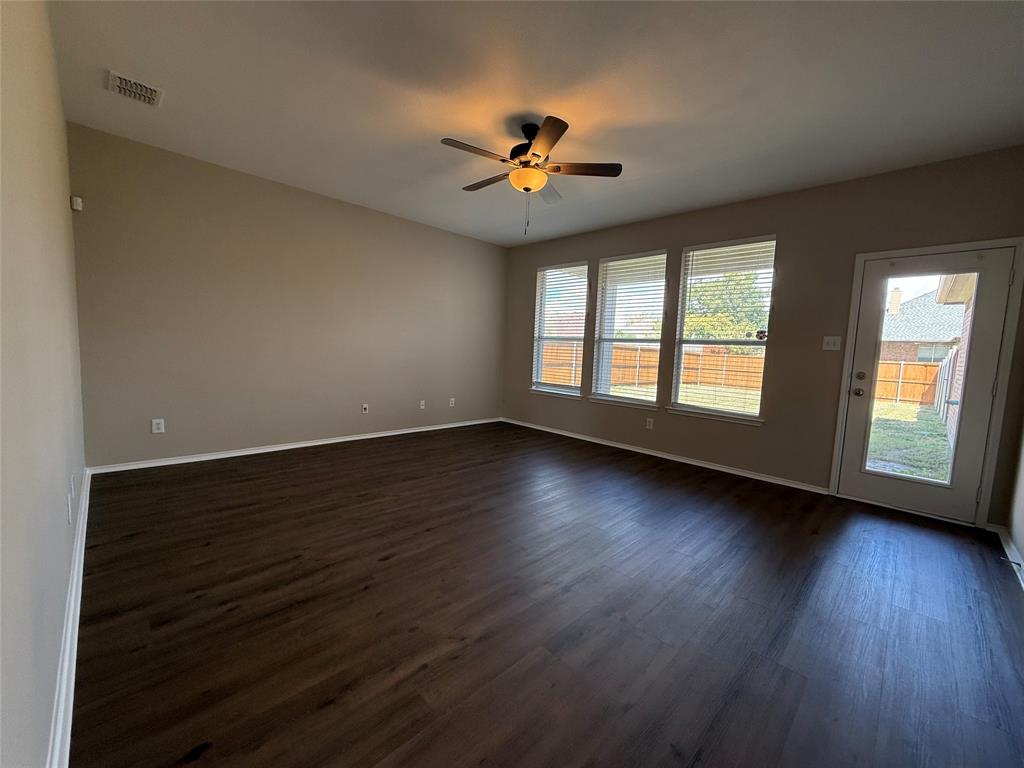 109 Rockbrook Drive Wylie, TX 75098 - Photo 5 of 34 a view of empty room with wooden floor and fan