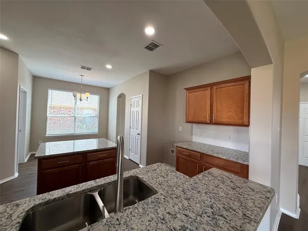 a living room with a rug and a dresser
