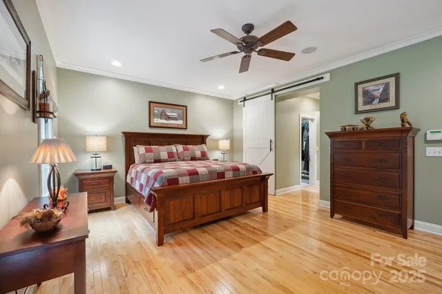 a spacious bedroom with a bed and a chandelier