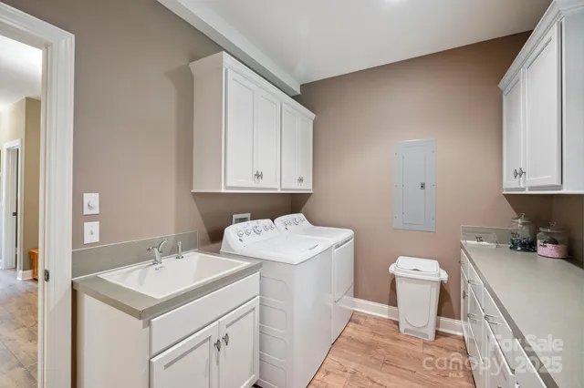 a bathroom with a sink toilet and cabinets