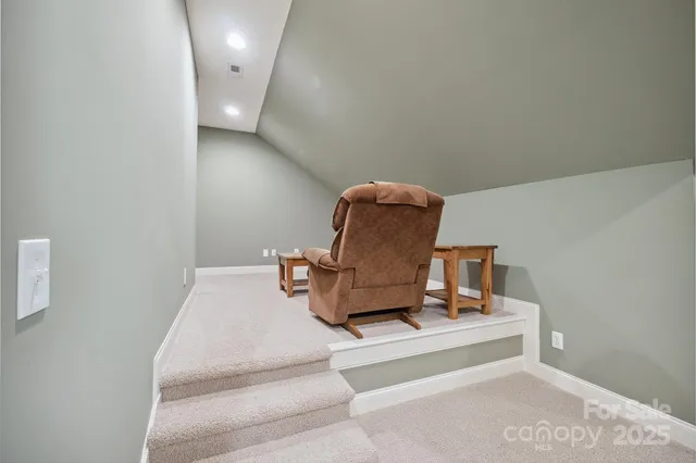 a bathroom with a granite countertop sink toilet and mirror