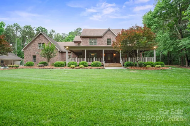 a front view of a house with a garden and plants