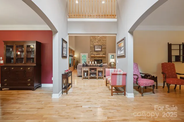 a living room with furniture and a dining table with rug