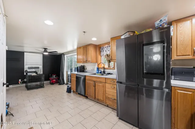 a kitchen with refrigerator and window