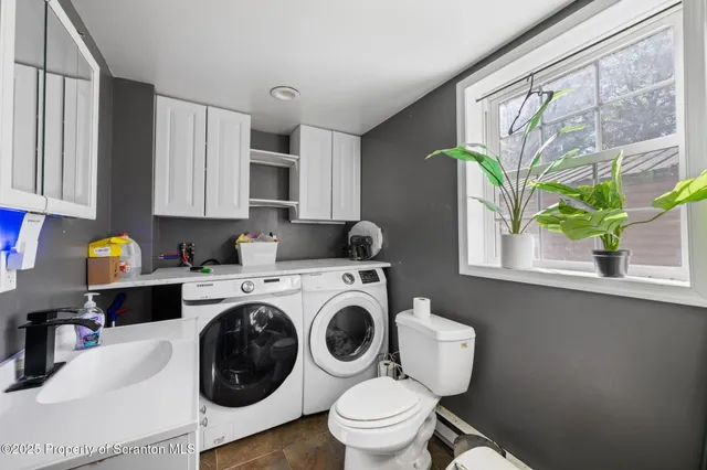 a kitchen with a stove a sink and a cabinetry