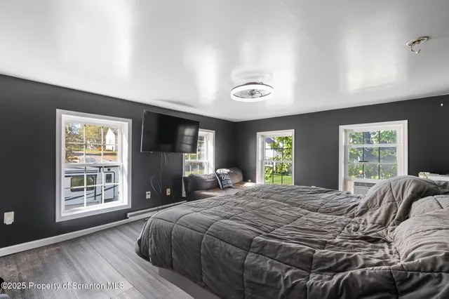 a bedroom with a large bed and a window