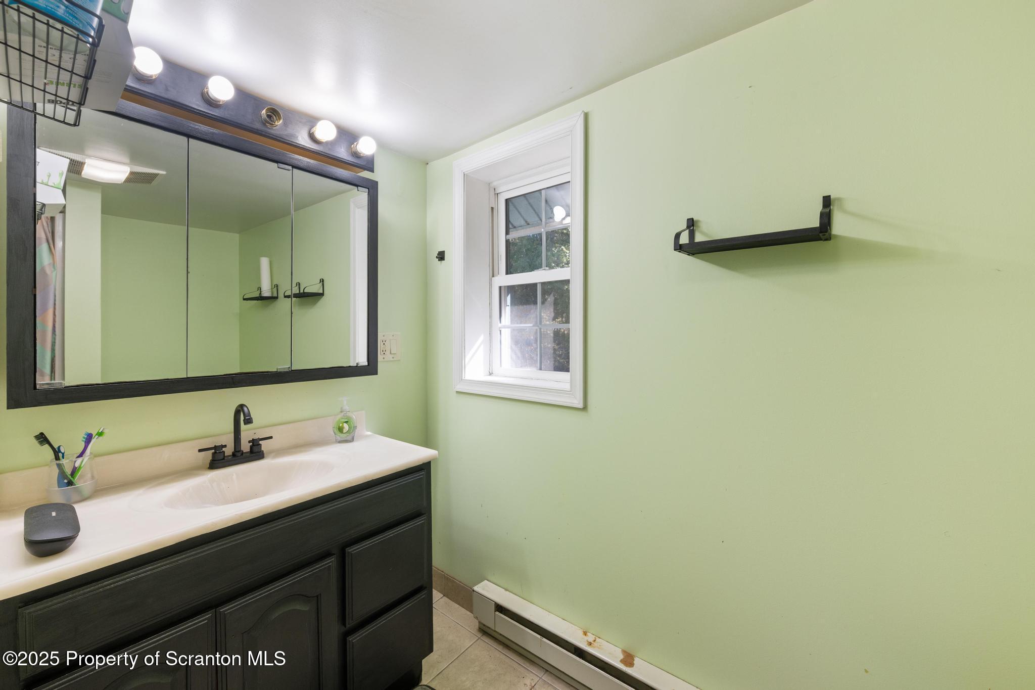 22 Creamery Road Tunkhannock, PA 18657 - Photo 22 of 39 a bathroom with a sink and a mirror