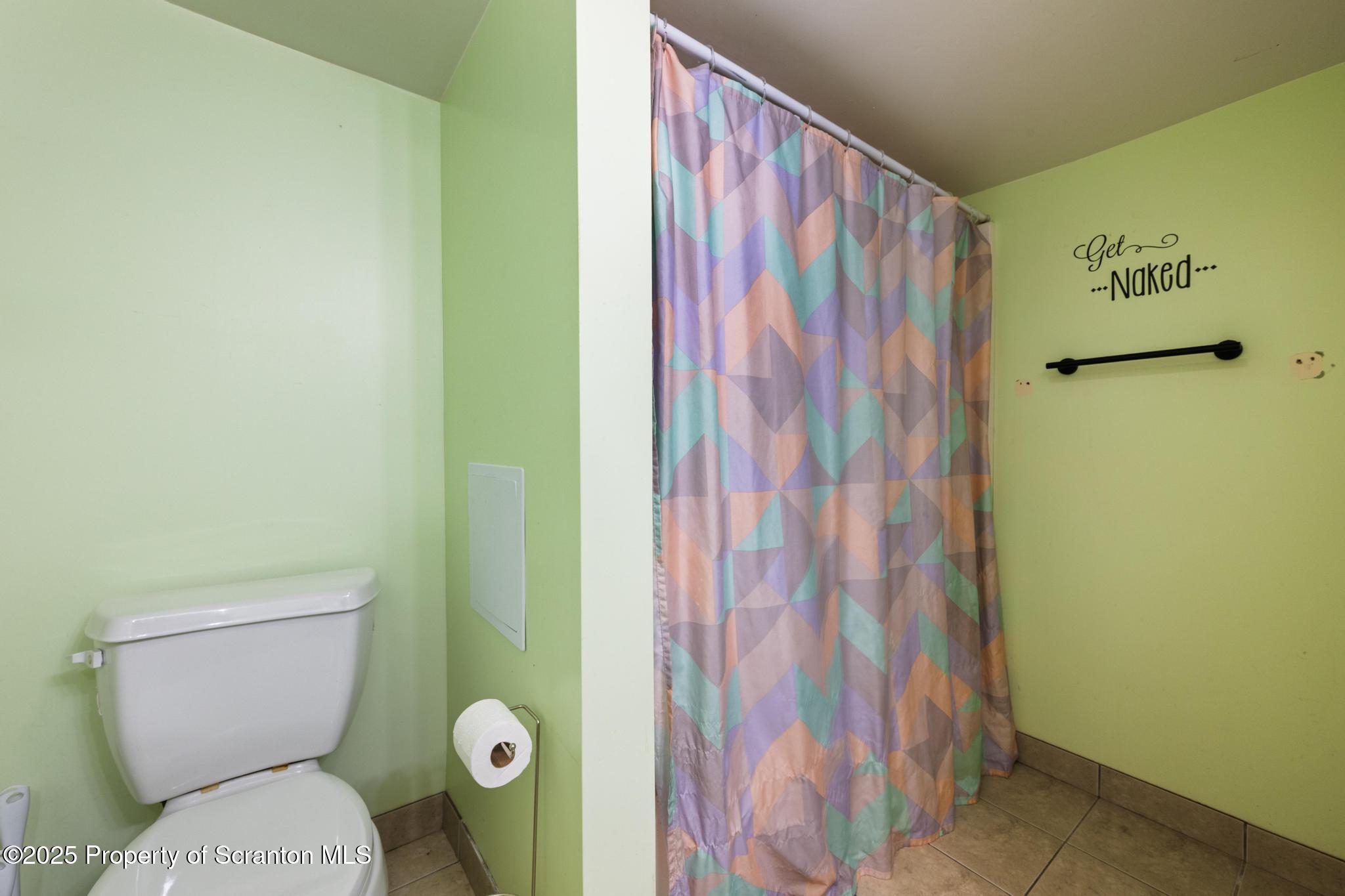 22 Creamery Road Tunkhannock, PA 18657 - Photo 23 of 39 a bathroom with a toilet and a shower curtain