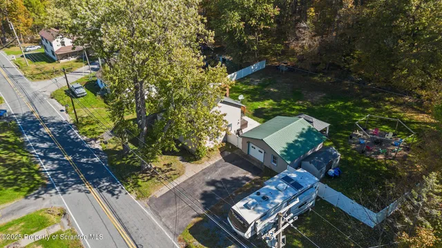 an aerial view of residential house with outdoor space and swimming pool