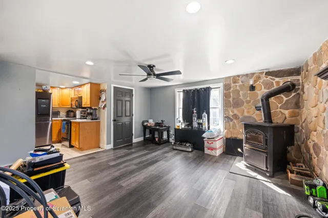 a living room with furniture a fireplace and city view