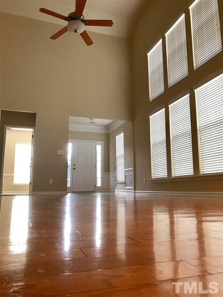 3409 Secretariat Way Raleigh, NC 27614 - Photo 11 of 30 2 story's of windows in the living room, giving tons of natural light.