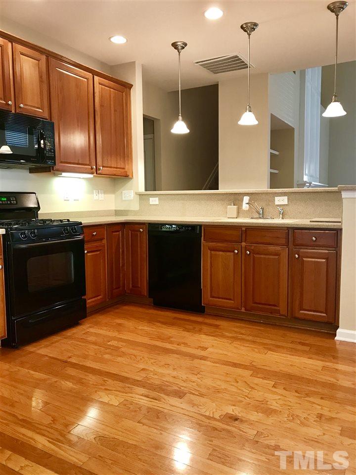 3409 Secretariat Way Raleigh, NC 27614 - Photo 30 of 30 Pendant lighting, gleaming hardwood flooring, the kitchen and views are amazing, in this open floor plan.