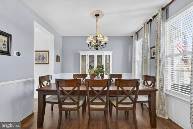 a view of a dining room with furniture wooden floor and a chandelier