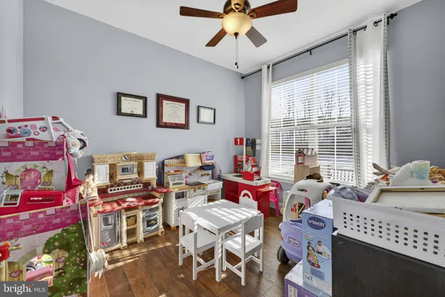 a bedroom with furniture and a large window