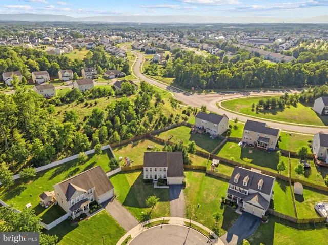 an aerial view of a house with a swimming pool
