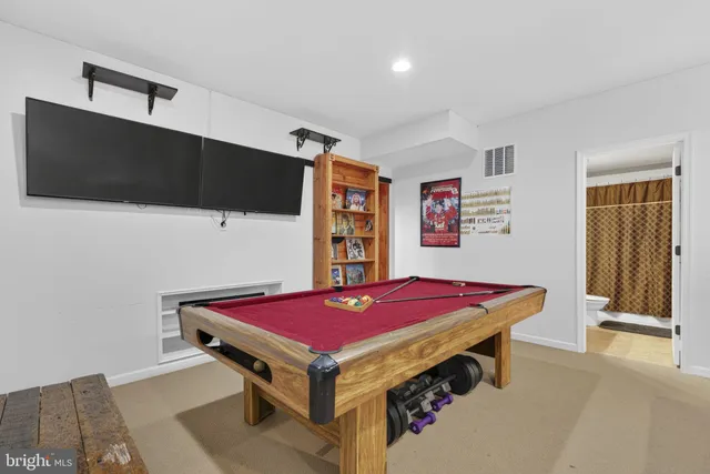 a room with pool table and a flat screen tv