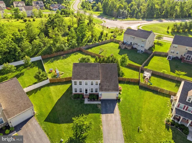 an aerial view of a house with a swimming pool