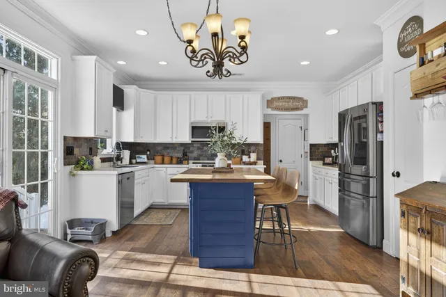 a kitchen with refrigerator cabinets dining table and chairs