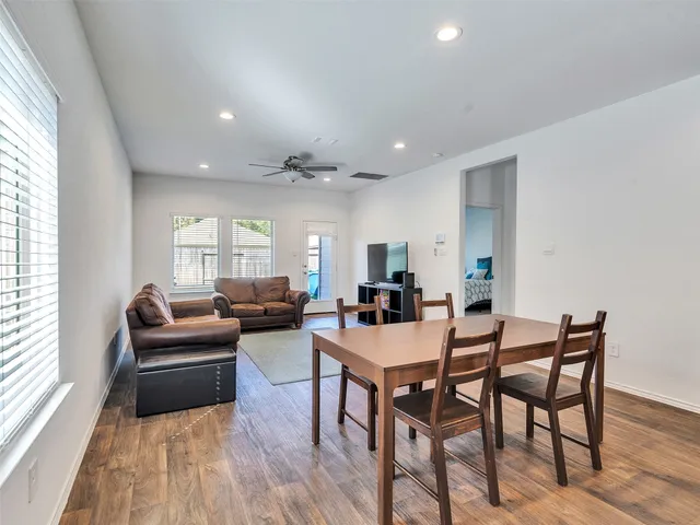 a view of a dining room with furniture and wooden floor