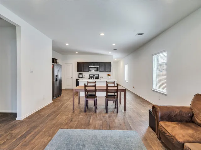a view of a dining room with furniture and wooden floor