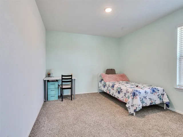 a bedroom with a bed and a table in it