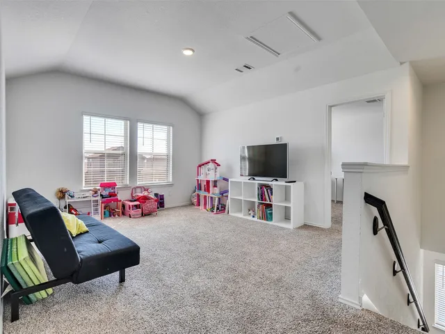 a view of a livingroom with furniture and a flat screen tv