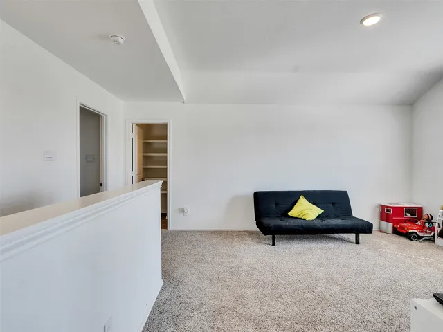 a view of a livingroom with wooden floor and fire pit