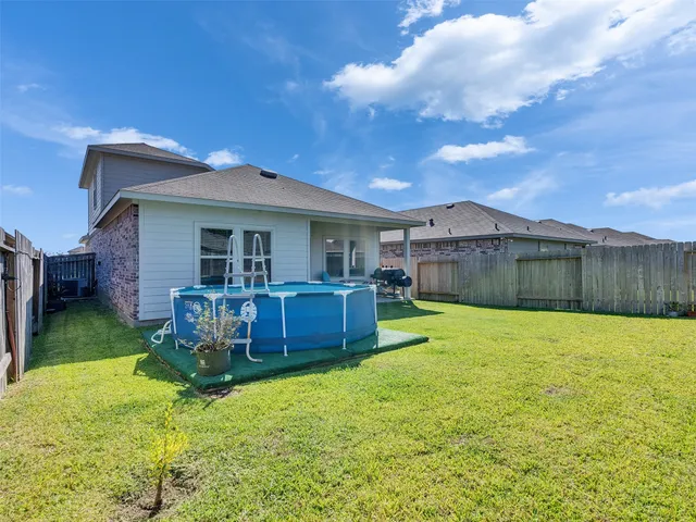 a view of an house with backyard space and backyard