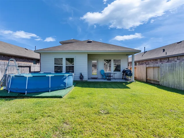 a view of an house with backyard space and balcony