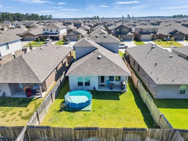 an aerial view of a house with swimming pool