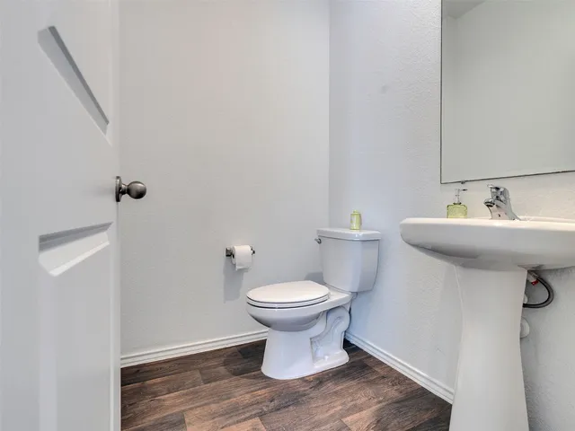 a bathroom with a sink toilet and a mirror