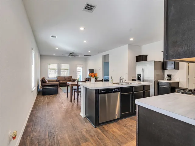 a kitchen with lots of counter top space and stainless steel appliances