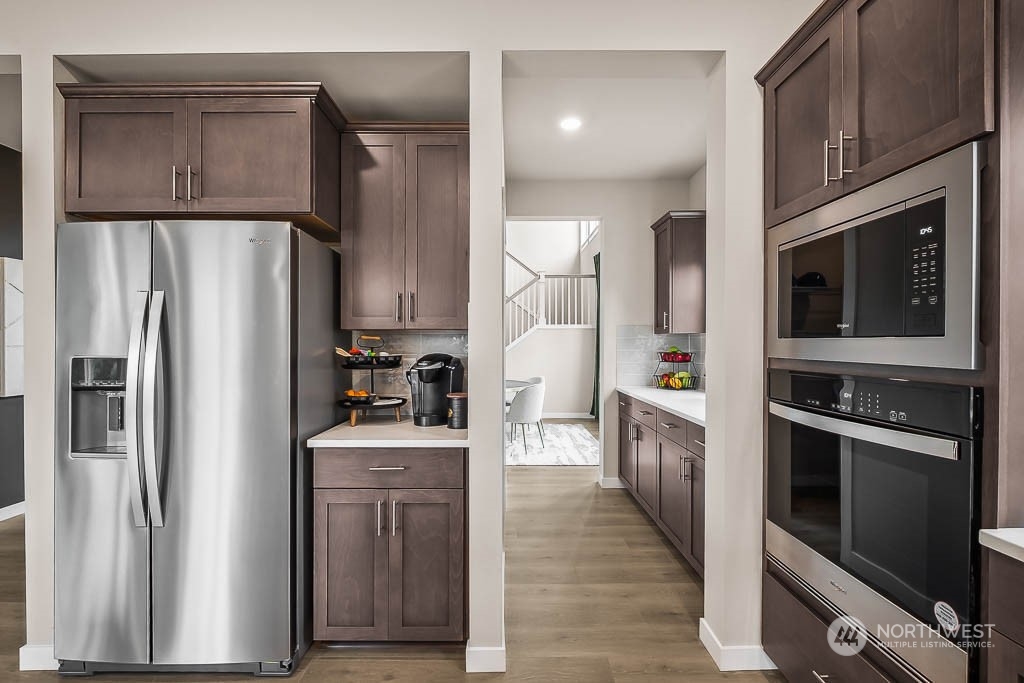 16213 Southeast 133rd Place, Unit 113 Renton, WA 98059 - Photo 13 of 30 a kitchen with a refrigerator stove and sink