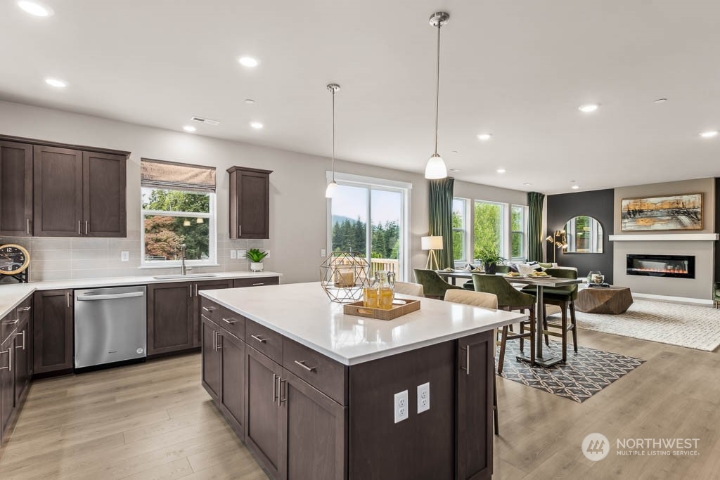 16213 Southeast 133rd Place, Unit 113 Renton, WA 98059 - Photo 16 of 30 a kitchen with a stove and kitchen island